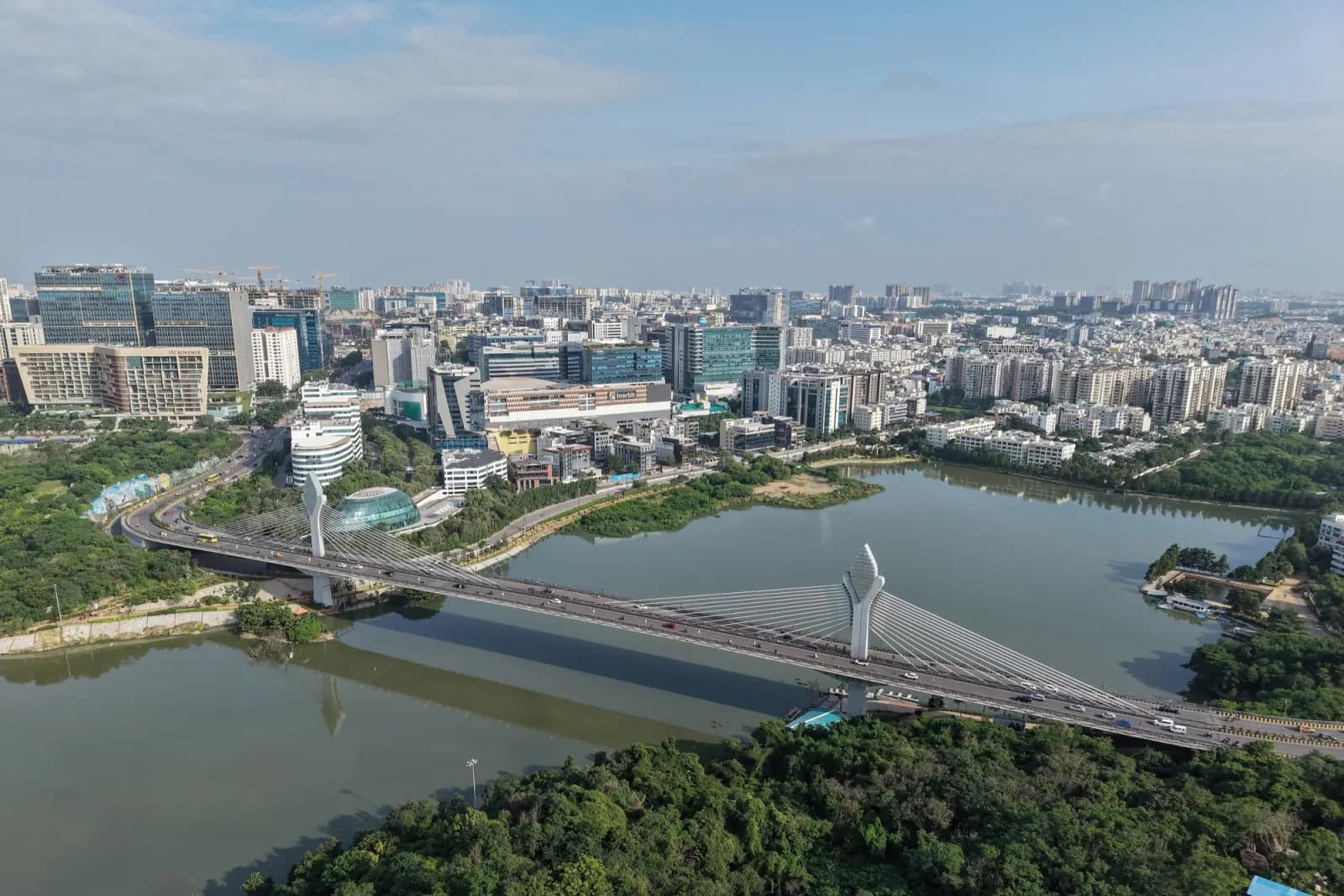 Aerial view of Durgam Cheruvu cable bridge with the Hitec City and Gachibowli skyline behind it